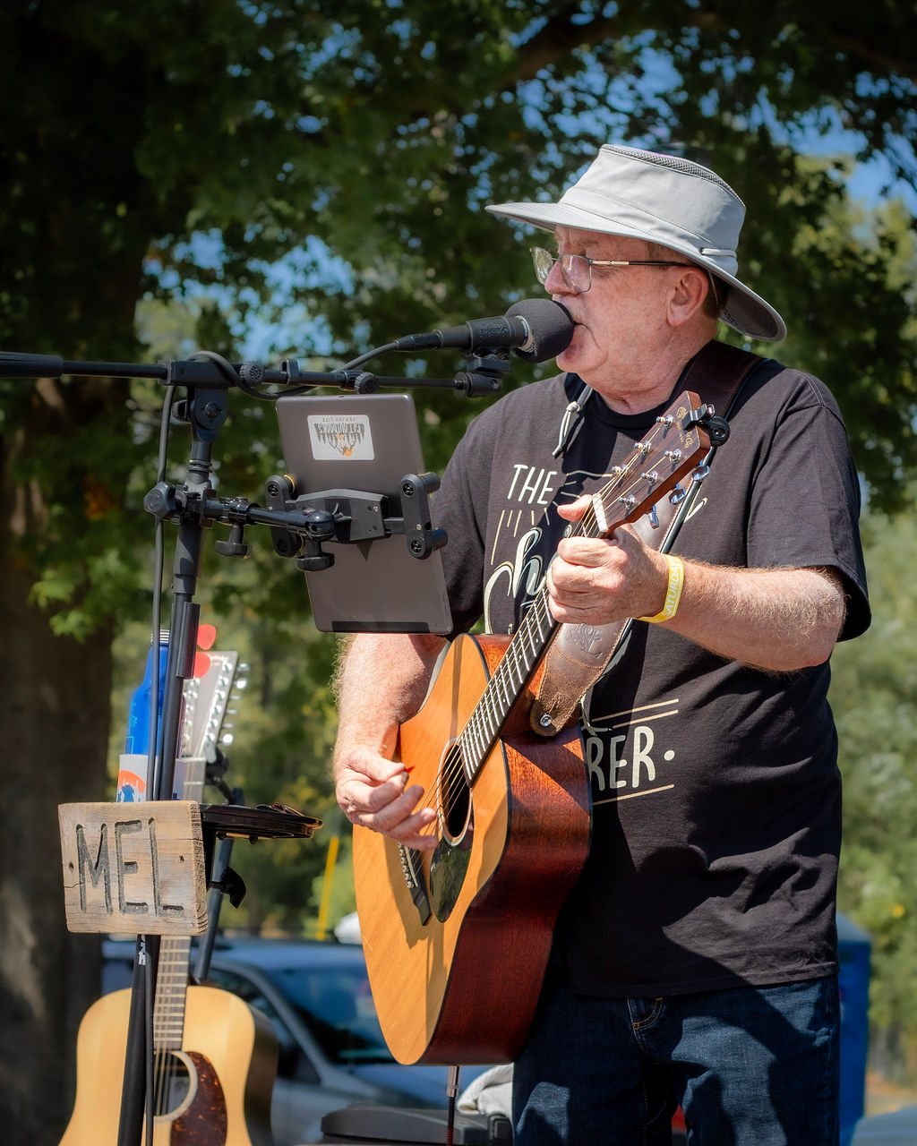Close-up of Mel Hughes singing live, wearing his hat